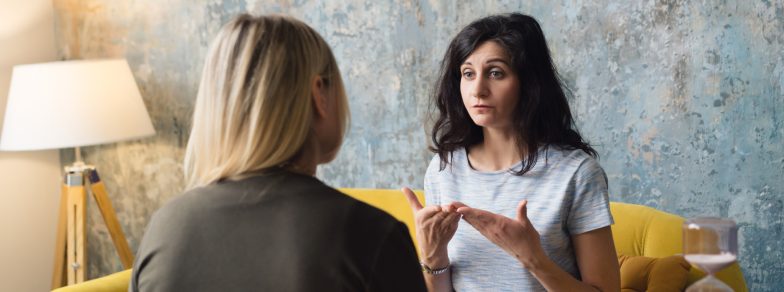 Distressed woman talking to therapist one on one